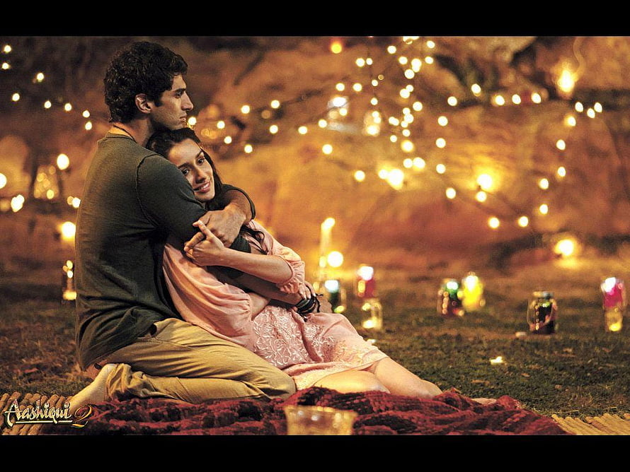 Aashiqui 2 Romantic Couple Embrace Under Warm String Lights and Candles HD wallpaper