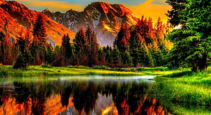 Alpine Lake Reflection at Golden Hour with Snow-Capped Peaks and Evergreen Forest HD wallpaper