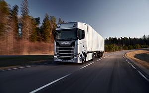 Silver Scania S-Series Semi Truck Hauling White Trailer on Forest Highway at Dusk HD wallpaper