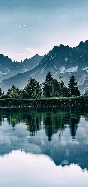 Serene Alpine Lake Reflection with Snow-Capped Peaks and Evergreen Forest HD phone wallpaper