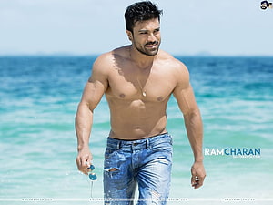 Ram Charan Walking on a Sunny Beach in Distressed Denim Jeans HD wallpaper