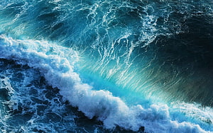 Aerial View of Turbulent Ocean Waves with White Foam and Deep Blue Water HD wallpaper