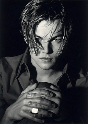 Leonardo DiCaprio Black and White Portrait with Intense Gaze and Clenched Hands HD phone wallpaper