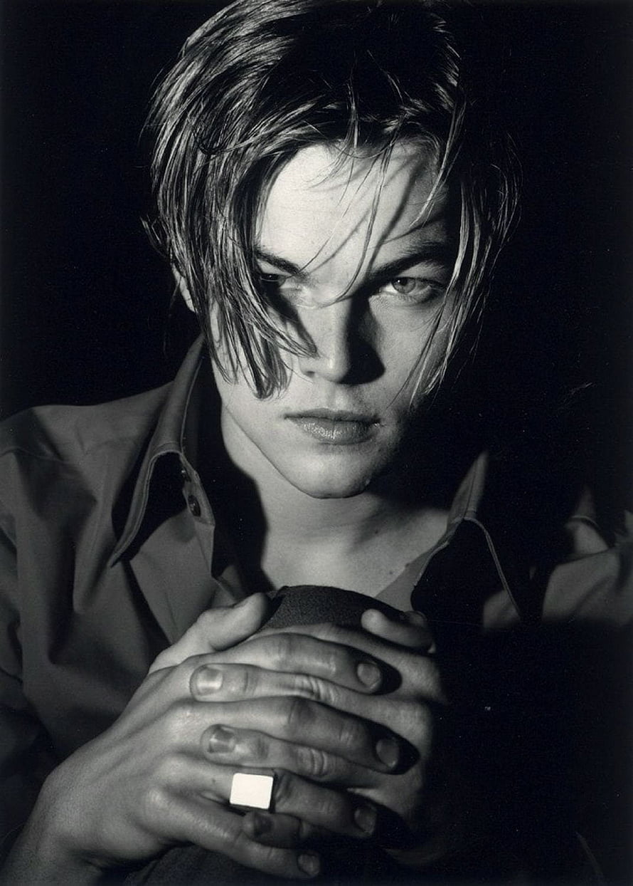 Leonardo DiCaprio Black and White Portrait with Intense Gaze and Clenched Hands HD phone wallpaper