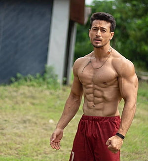 Tiger Shroff shirtless outdoor fitness portrait in red shorts HD phone wallpaper