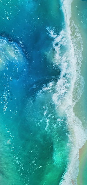 Aerial View of Turquoise Ocean Waves Crashing on Sandy Shore HD phone wallpaper