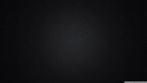 Minimalist Dark Charcoal Texture with Subtle Grain and Soft Vignette HD wallpaper