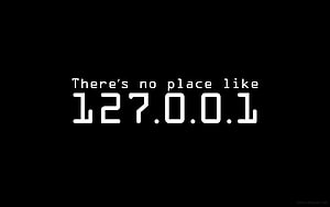 Minimalist Black Background with White Monospace Text Reading There's No Place Like 127.0.0.1 HD wallpaper