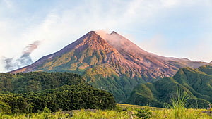 Mount Merapi Volcano Rising Above Lush Green Hills in Central Java HD wallpaper