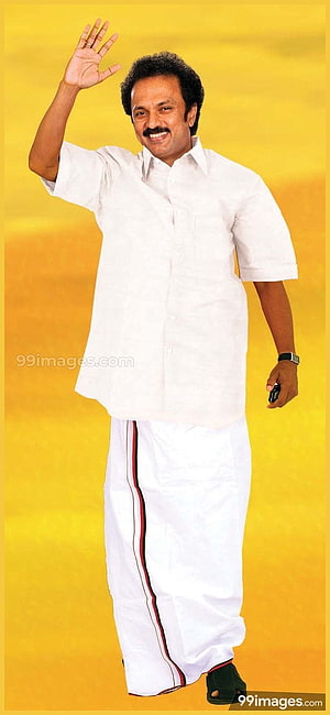 M. K. Stalin in white shirt and dhoti waving against a yellow background HD phone wallpaper