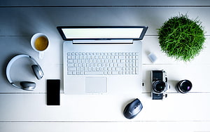 Minimalist Workspace Flat Lay With Laptop, Camera, Headphones, Coffee, and Plant on White Wood Desk HD wallpaper