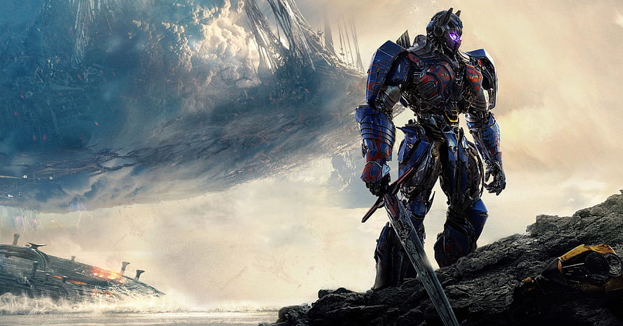Optimus Prime from Transformers: The Last Knight Standing on a Rocky Cliff with a Massive Ship in the Background HD wallpaper