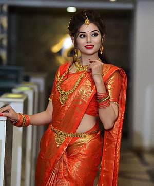 Elegant Woman in Traditional Orange Silk Saree with Gold Jewelry and Bangles, stock of beautiful girl, desi girl, desi girls, beautiful desi girl HD phone wallpaper