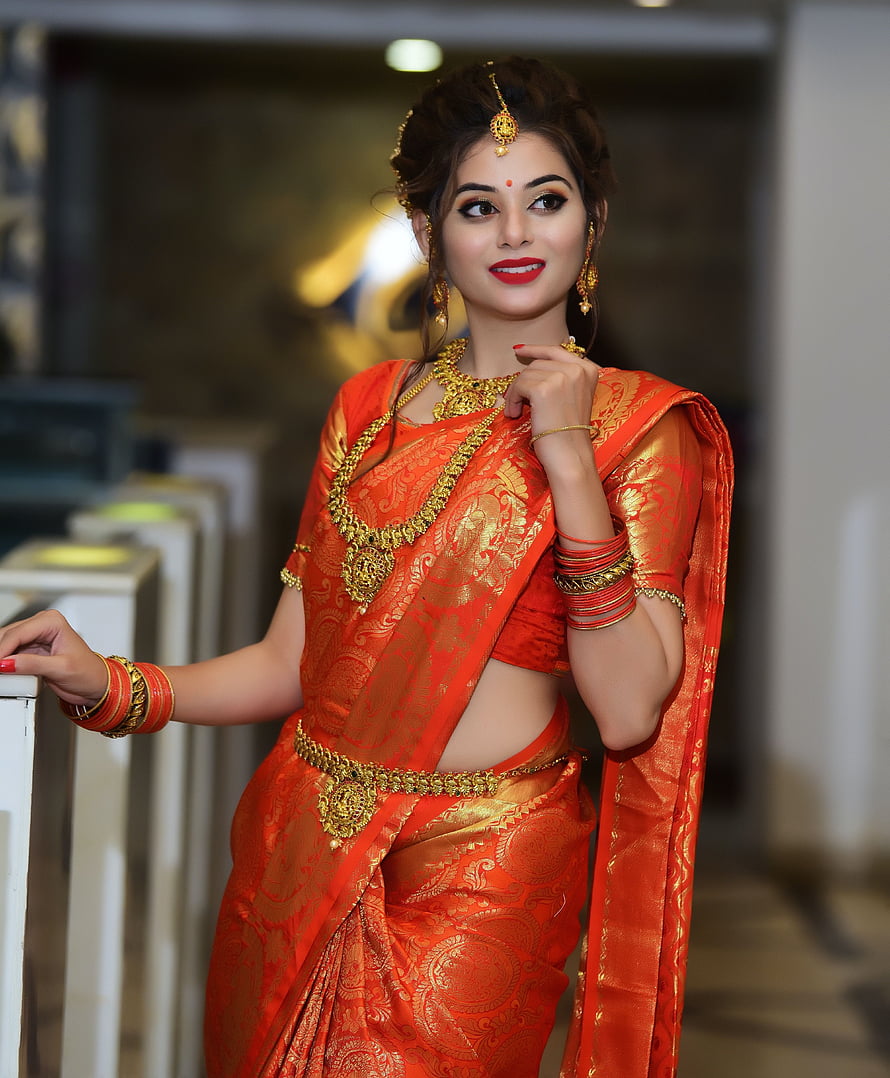 Elegant Woman in Traditional Orange Silk Saree with Gold Jewelry and Bangles, stock of beautiful girl, desi girl, desi girls, beautiful desi girl HD phone wallpaper
