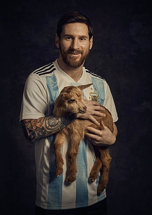 Lionel Messi in Argentina jersey holding a young goat in a studio portrait HD phone wallpaper