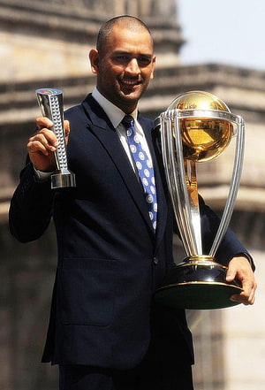 MS Dhoni Holding ICC Cricket World Cup Trophy and Player of the Tournament Award HD phone wallpaper