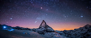 Matterhorn Peak Under a Starry Night Sky with Aurora and Snowy Alpine Landscape HD wallpaper
