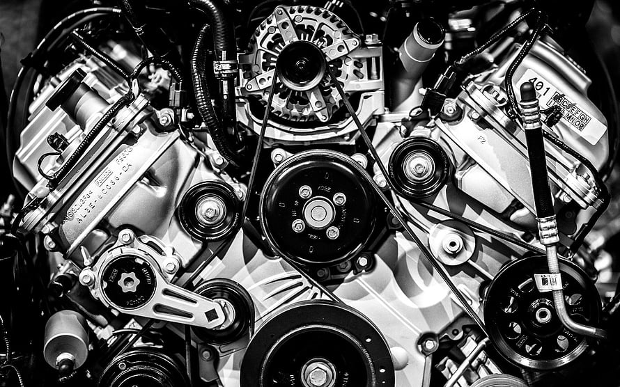 Black and White Close-Up of a Complex Car Engine with Pulleys and Belts HD wallpaper