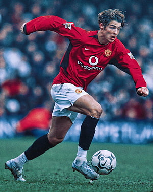 Cristiano Ronaldo in Manchester United Red Kit Dribbling Ball on Pitch HD phone wallpaper