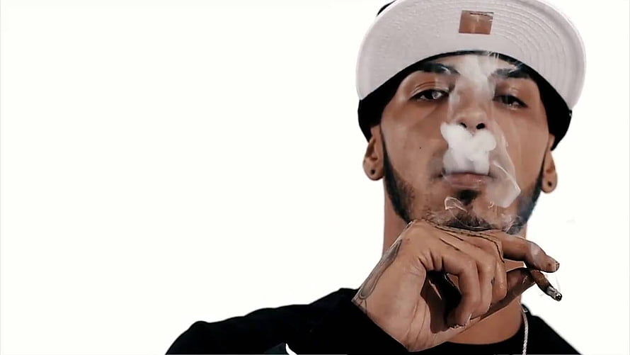 Anuel AA Portrait Smoking Cigar With White Cap and Black Shirt HD wallpaper