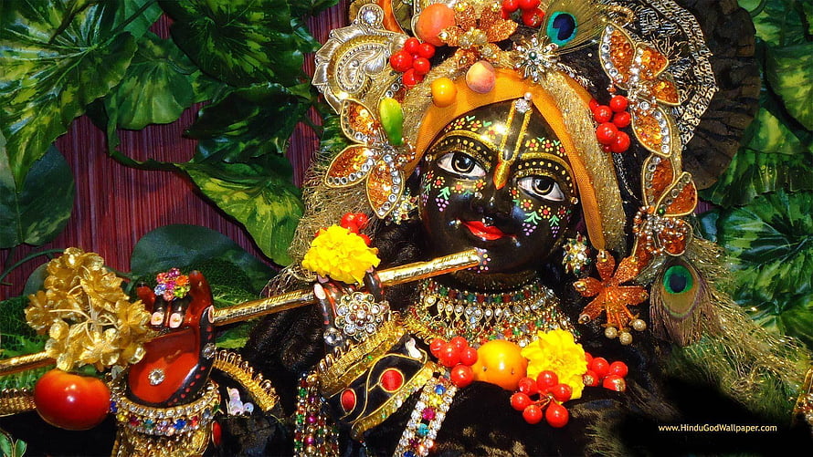 Ornate Krishna Idol Playing Flute with Peacock Crown and Floral Garland HD wallpaper