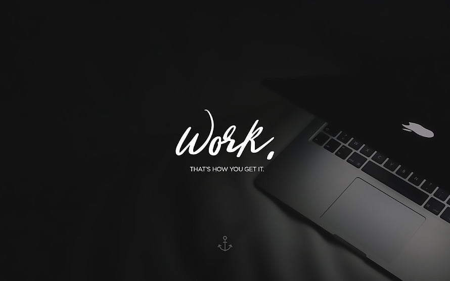 Minimalist Dark Laptop Workspace with Motivational Work Quote and Anchor Icon HD wallpaper