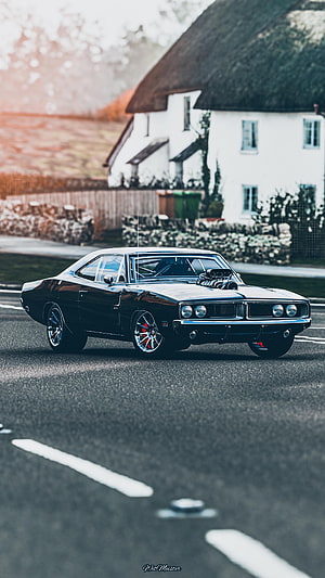 Black Dodge Charger Muscle Car on Country Road with Thatched Cottage HD phone wallpaper