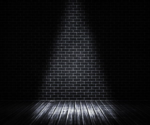 Moody Black Brick Wall with Wooden Floor and Central Spotlight HD wallpaper