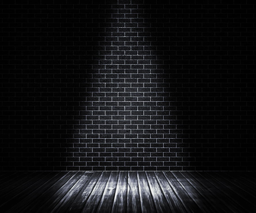 Moody Black Brick Wall with Wooden Floor and Central Spotlight HD wallpaper