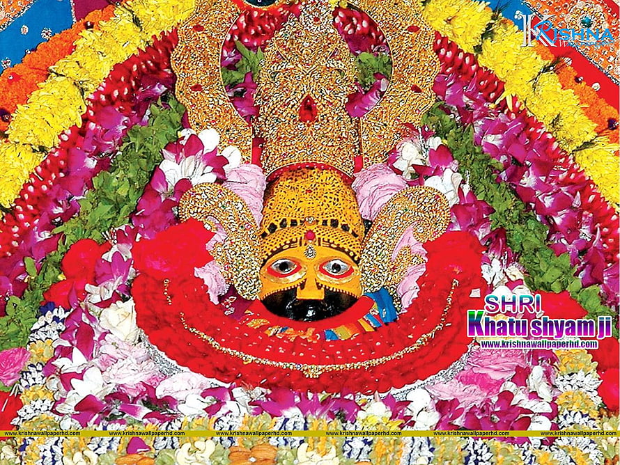 Shri Khatu Shyam Ji adorned in vibrant floral garlands and ornate golden crown HD wallpaper
