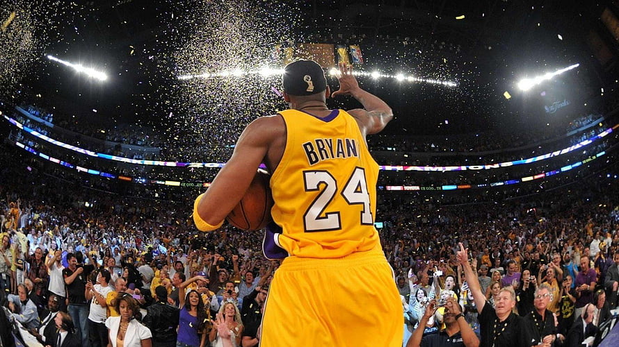 Kobe Bryant Celebrating Championship Victory with Trophy and Confetti in Arena HD wallpaper
