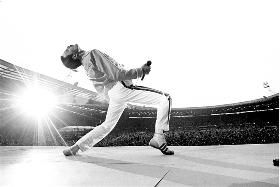 Freddie Mercury performing the iconic lean at Wembley Stadium during Live Aid 1985 HD wallpaper