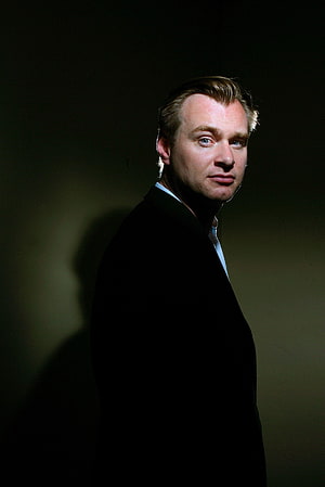 Christopher Nolan Dramatic Studio Portrait in Black Suit Against Dark Background HD phone wallpaper