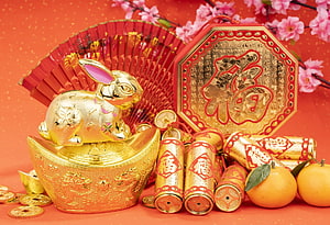 Golden Rabbit on Ingot with Firecrackers and Plum Blossoms for Lunar New Year HD wallpaper