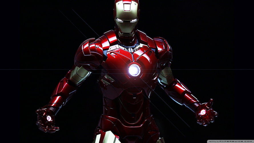 Iron Man Red and Gold Armor with Glowing Arc Reactor on Black Background HD wallpaper