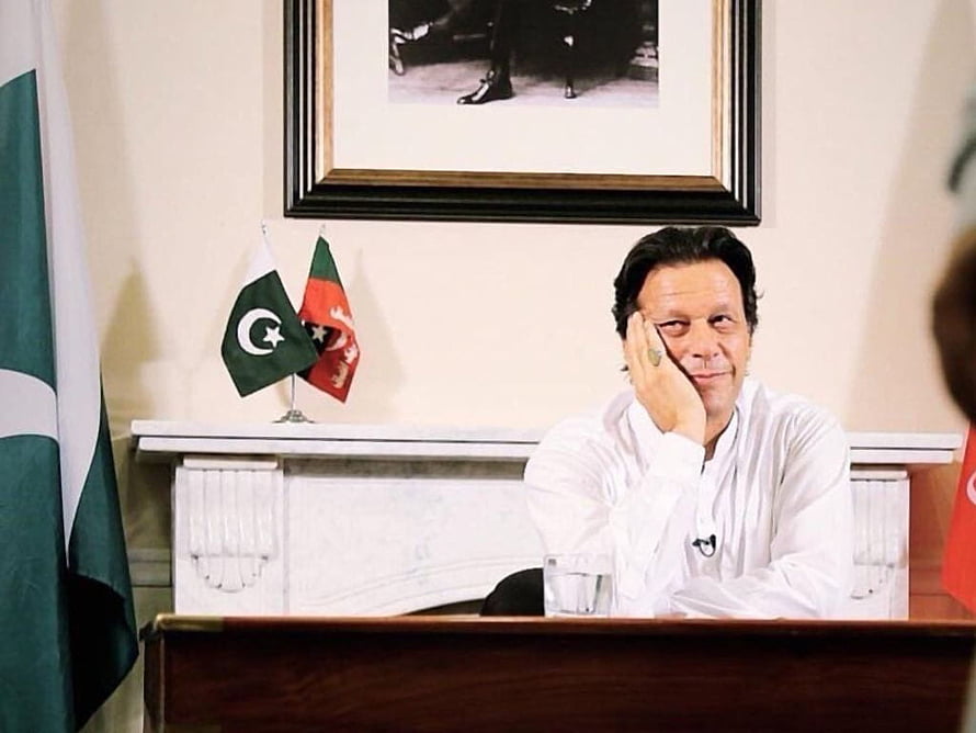 Imran Khan Seated at Desk in Formal White Attire with Pakistan Flag HD wallpaper