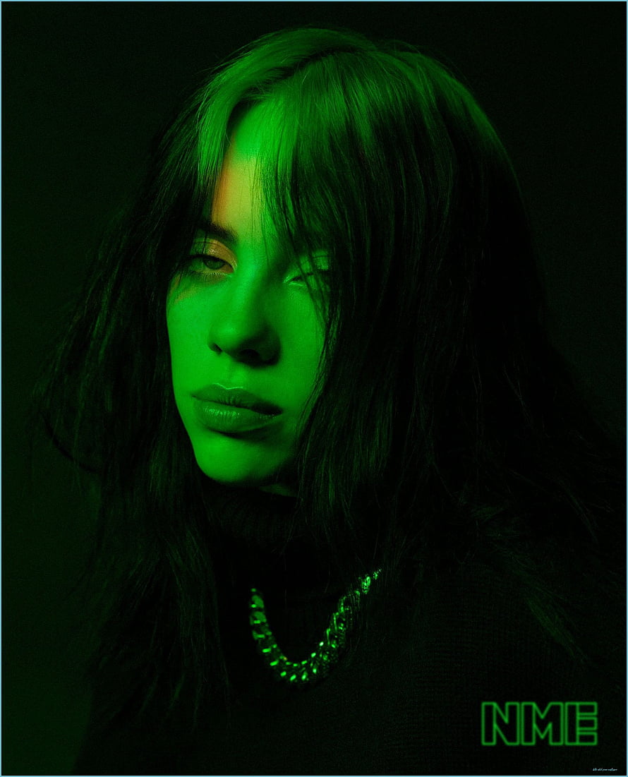 Billie Eilish moody green-lit portrait with dark hair and chain necklace HD phone wallpaper