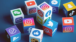 Colorful 3D Cubes Featuring Popular Social Media App Icons on a Blue Background HD wallpaper